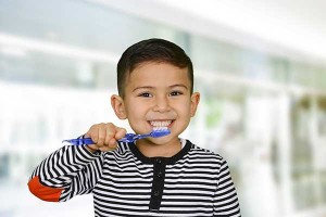 cute boy brushing teeth